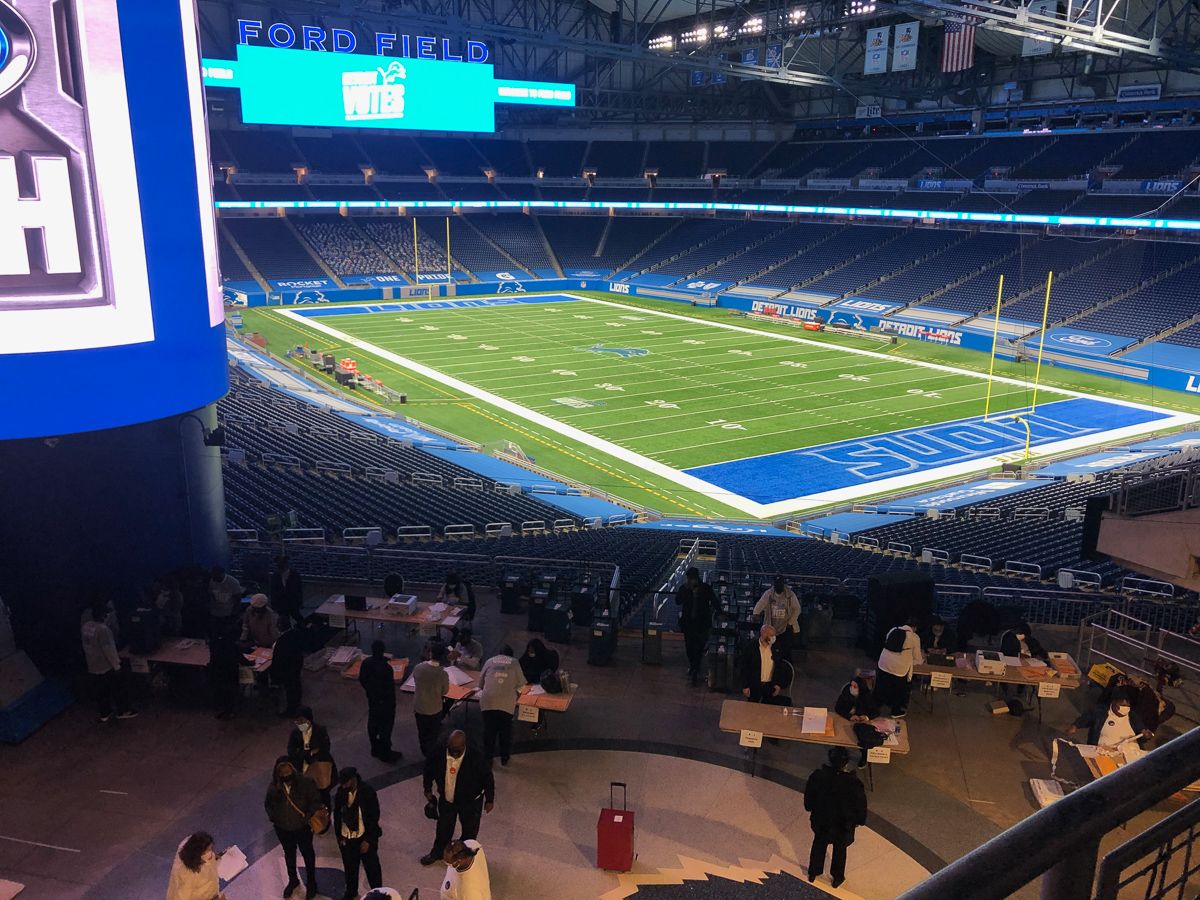 Receiving board tables in foreground. Empty football field in background.