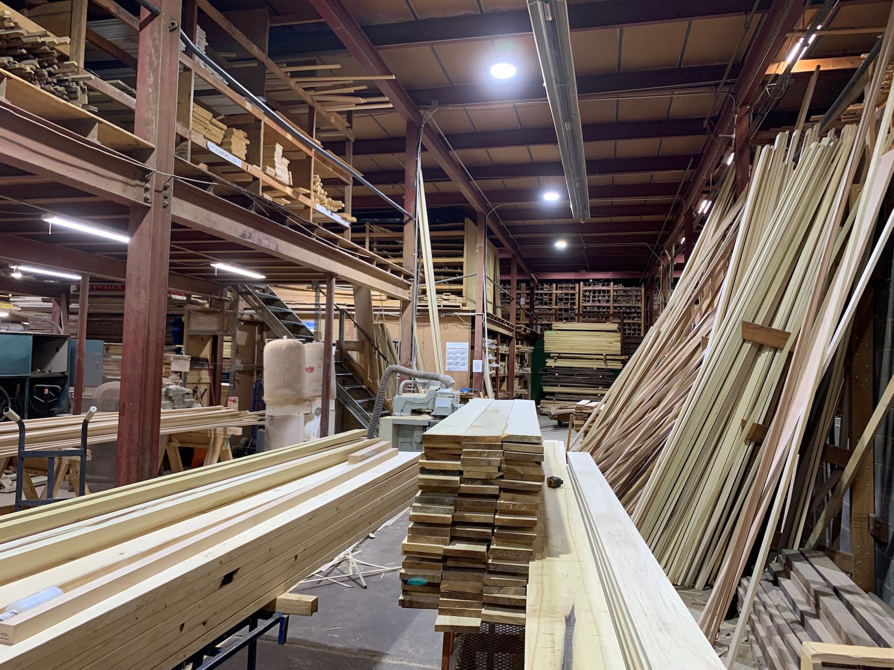 Stacks and piles of boards in warehouse space.