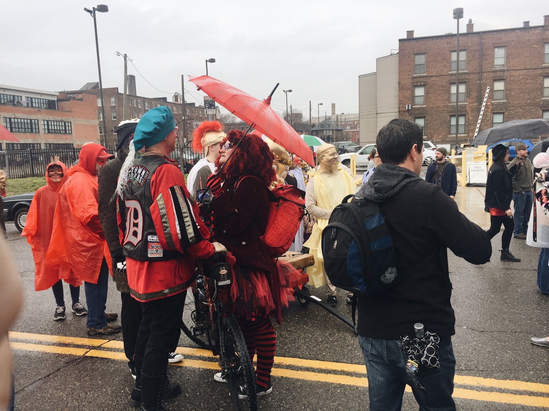 Rainy day paradegoers, dressed in red and black.