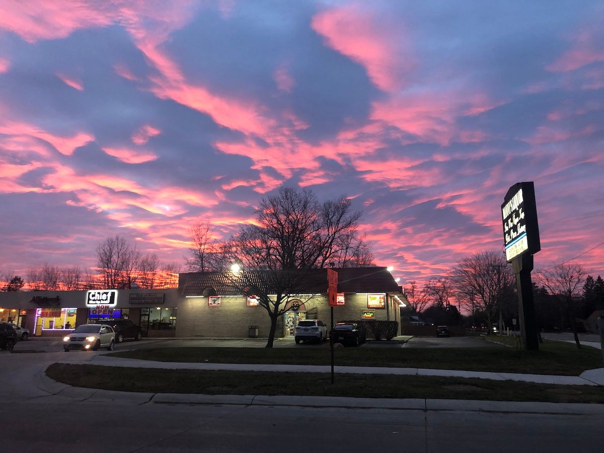 Orange clouds above a convenience store.