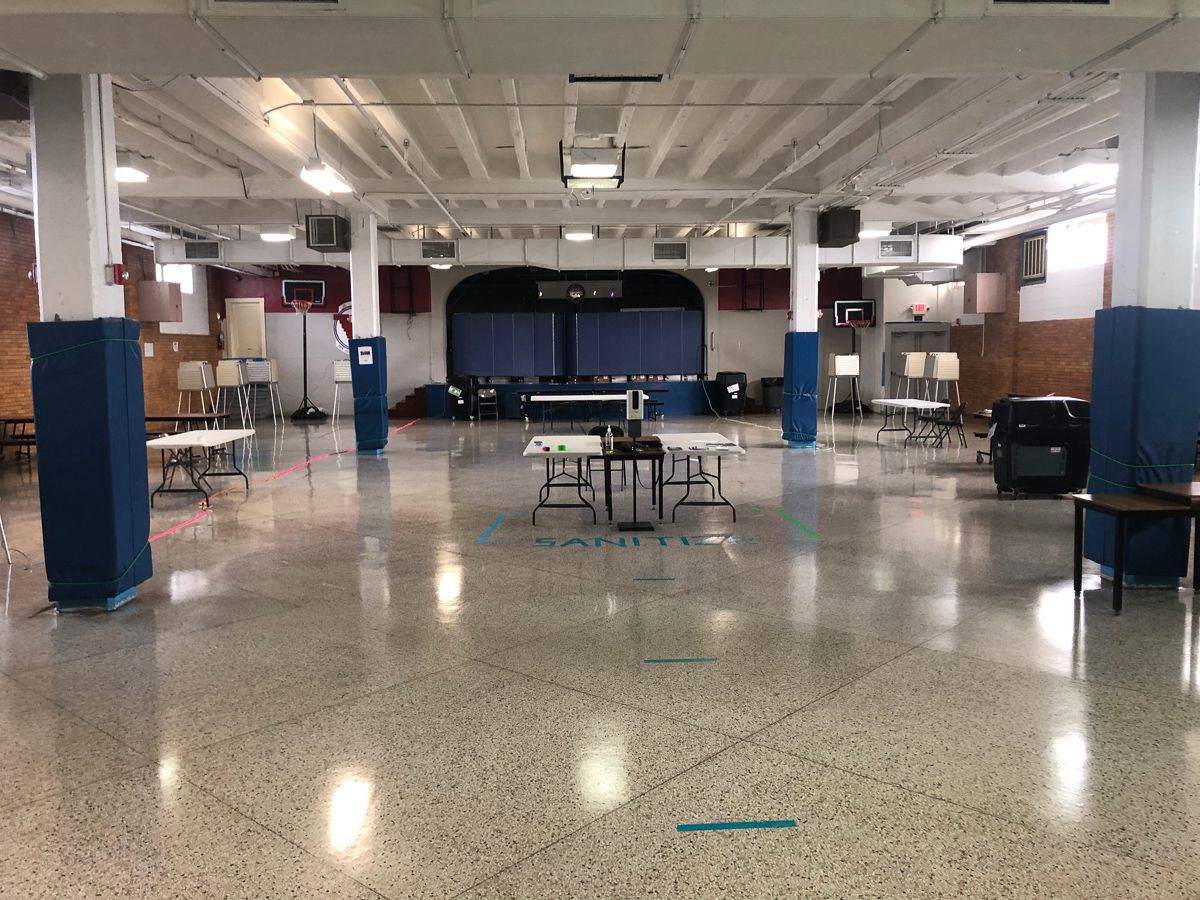 Polling site in an empty school cafeteria.