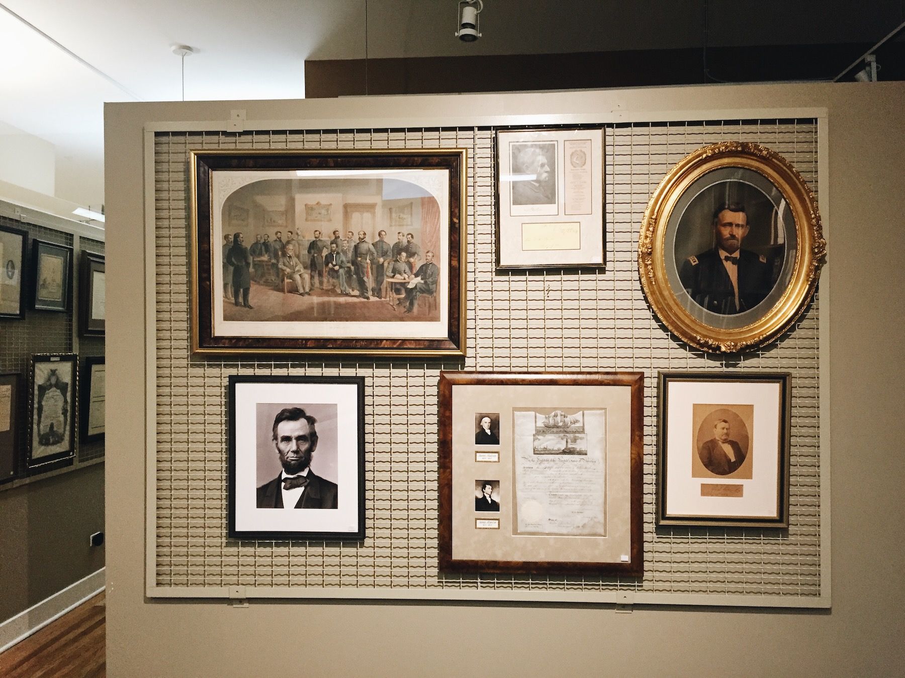 Photo wall in Abraham Lincoln Book Shop. Lincoln and other presidents. Hung on beige mesh grid.